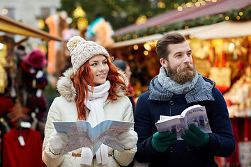 Image showing happy couple with map and city guide in old town