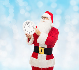 Image showing man in costume of santa claus with clock