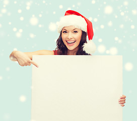 Image showing woman in santa helper hat with blank white board