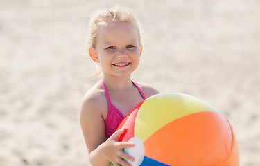 Image showing happy little girl playing inflatable ball on beach