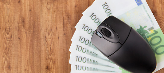 Image showing close up of computer mouse and euro money