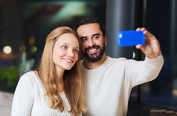 Image showing happy couple with tablet pc and coffee at cafe