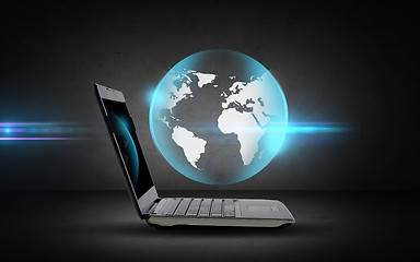 Image showing open laptop computer with globe projection