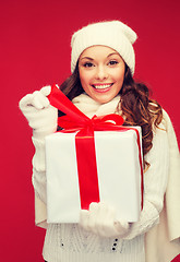 Image showing smiling woman in white clothes with gift box