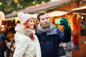 Image showing couple taking selfie with smartphone in old town