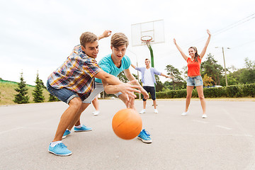 Image showing group of happy teenagers playing basketball