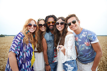 Image showing smiling young hippie friends on cereal field