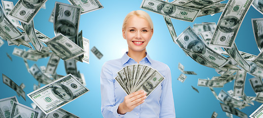 Image showing smiling businesswoman with dollar cash money