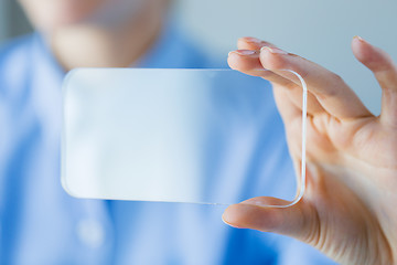 Image showing close up of woman with transparent smartphone