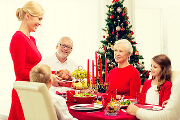 Image showing smiling family having holiday dinner at home