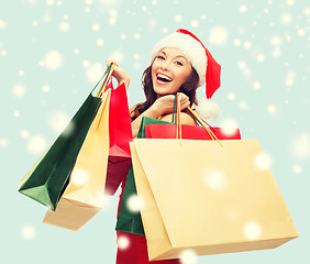 Image showing woman in red dress with shopping bags