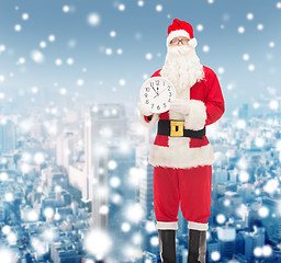 Image showing man in costume of santa claus with clock