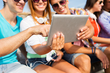 Image showing group of smiling friends with tablet pc outdoors