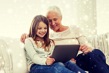 Image showing smiling family with tablet pc at home