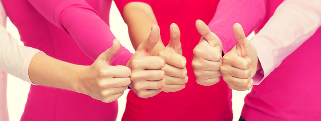 Image showing close up of women in pink shirts showing thumbs up