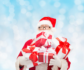 Image showing man in costume of santa claus with gift boxes