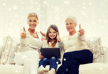 Image showing smiling family with tablet pc at home