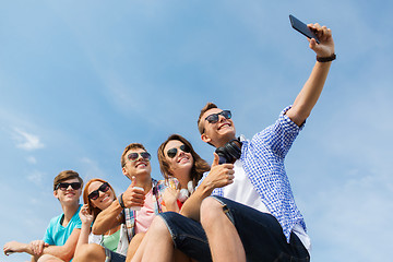 Image showing happy friends with smartphone taking selfie