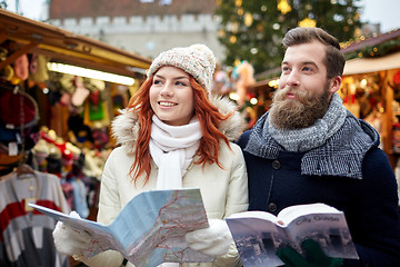 Image showing happy couple with map and city guide in old town