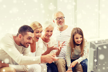 Image showing happy family watching tv at home