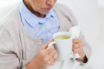 Image showing close up of sick senior woman drinking tea at home
