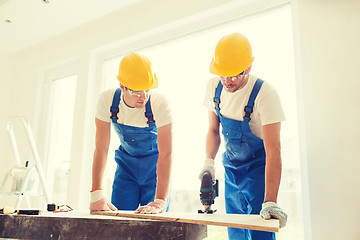 Image showing group of builders with tools indoors