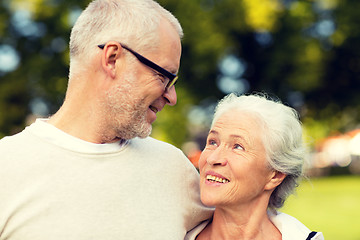 Image showing senior couple hugging in city park