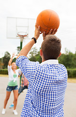 Image showing group of happy teenagers playing basketball