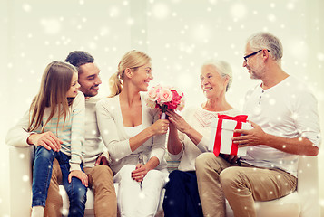 Image showing happy family with bunch and gift box at home