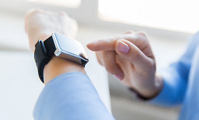 Image showing close up of hands setting smart watch