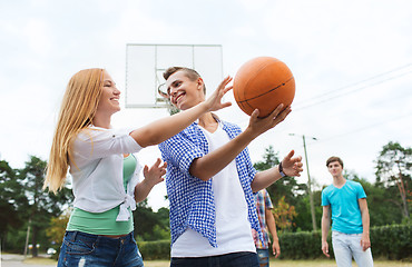 Image showing group of happy teenagers playing basketball