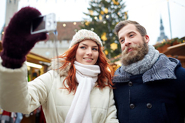 Image showing couple taking selfie with smartphone in old town