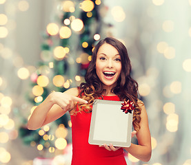 Image showing smiling woman in red dress with tablet pc