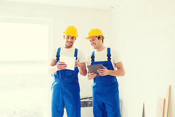 Image showing builders with tablet pc and equipment indoors