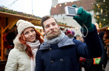 Image showing couple taking selfie with smartphone in old town