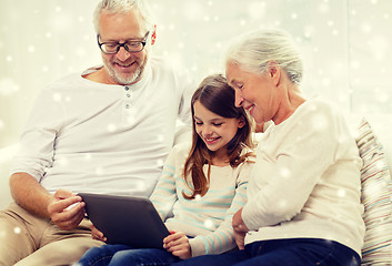 Image showing smiling family with tablet pc at home