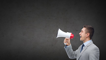 Image showing happy businessman in suit speaking to megaphone