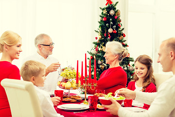 Image showing smiling family having holiday dinner at home