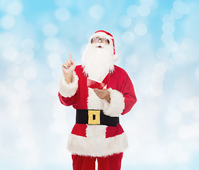 Image showing man in costume of santa claus with notepad