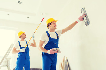 Image showing group of builders with tools indoors