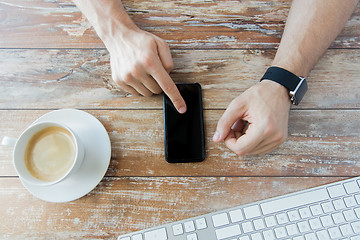 Image showing close up of hands with smart phone and watch