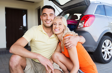 Image showing happy couple hugging at home car parking space