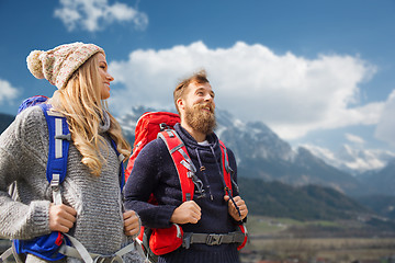 Image showing happy couple with backpacks hiking over mountains