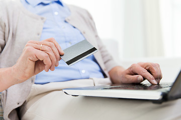 Image showing senior woman with laptop and credit card at home