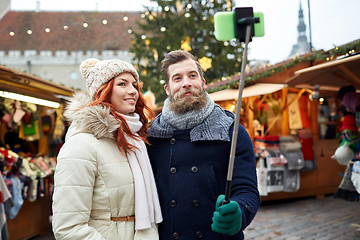 Image showing couple taking selfie with smartphone in old town