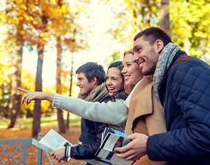 Image showing group of friends with map outdoors