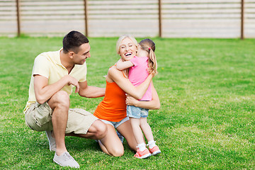 Image showing happy family hugging outdoors