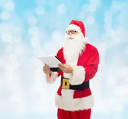 Image showing man in costume of santa claus with notepad