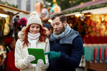 Image showing happy couple walking with tablet pc in old town