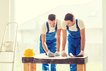 Image showing group of builders with blueprint